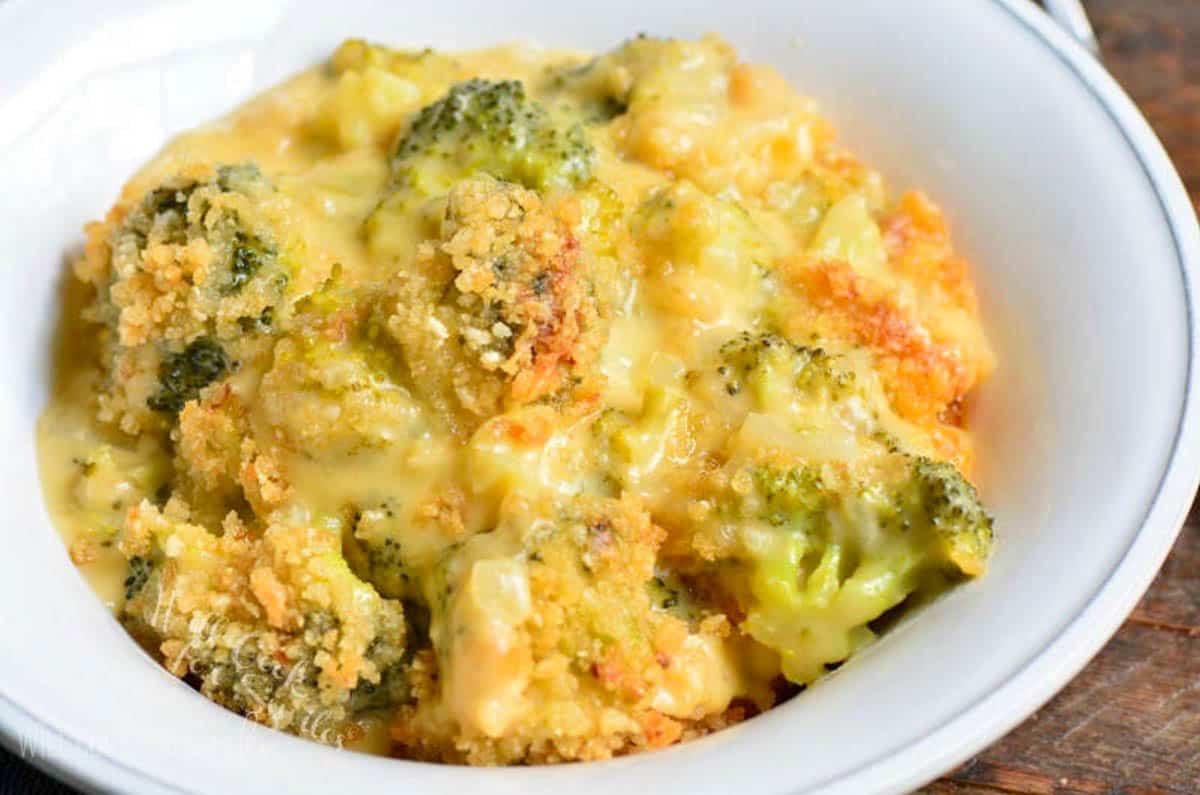 cheesy broccoli cheese casserole in a light bowl.