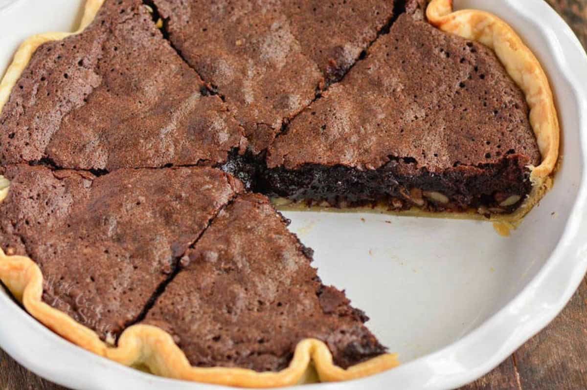 baked brownie pie in the dish, sliced, with one slice taken out.