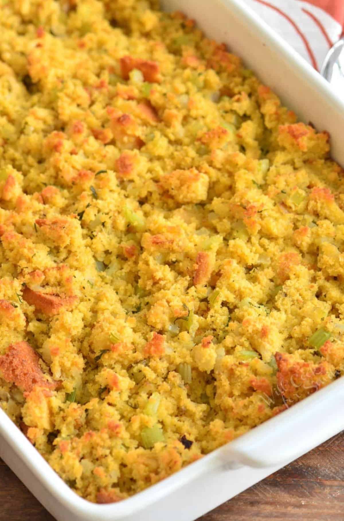 baked cornbread dressing in the white baking dish.