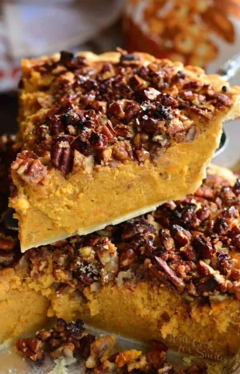 a slice of sweet potato pie with crunchy pecan topping on top of a whole pie.