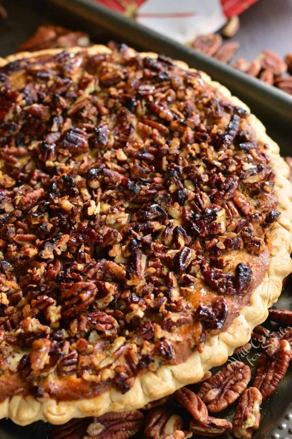 a whole baked sweet potato pie with pecan crunchy topping.