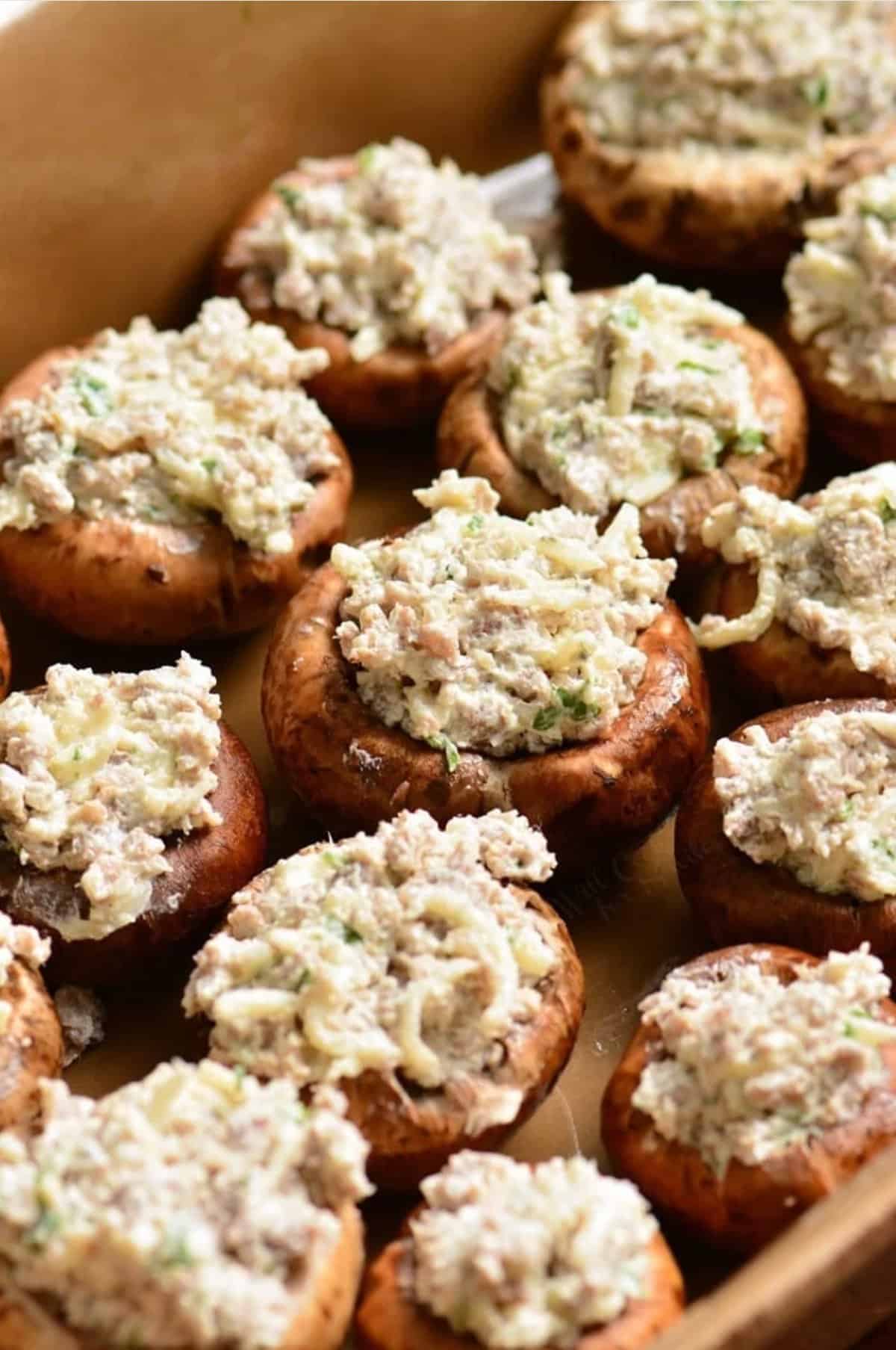 mushrooms stuffed with sausage stuffing on the baking dish before baking.