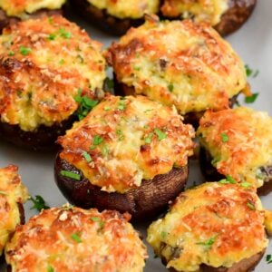 several stuffed mushrooms on the platter garnished with cilantro.