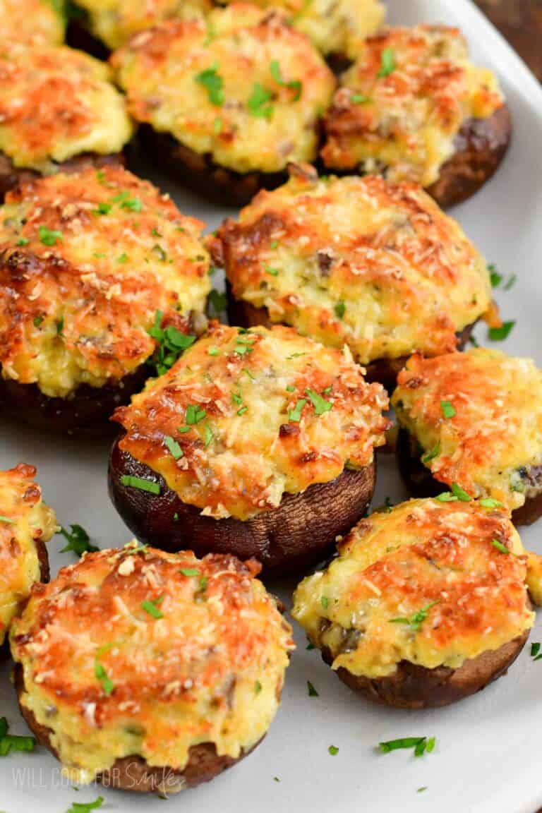 several stuffed mushrooms on the platter garnished with cilantro.