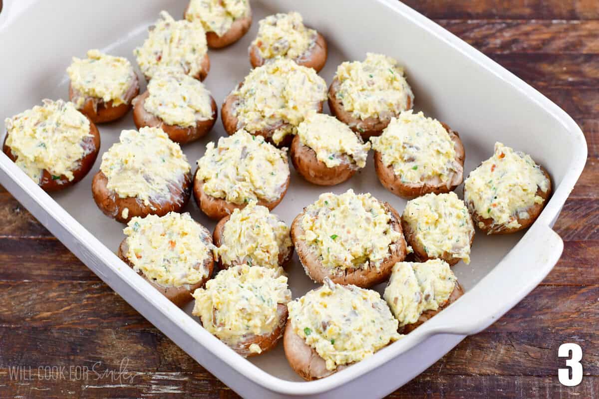 unbaked stuffed mushroom caps in the baking dish.