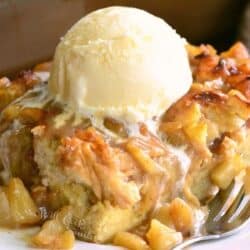 a slice of apple pie bread pudding on the plate with ice cream on top.