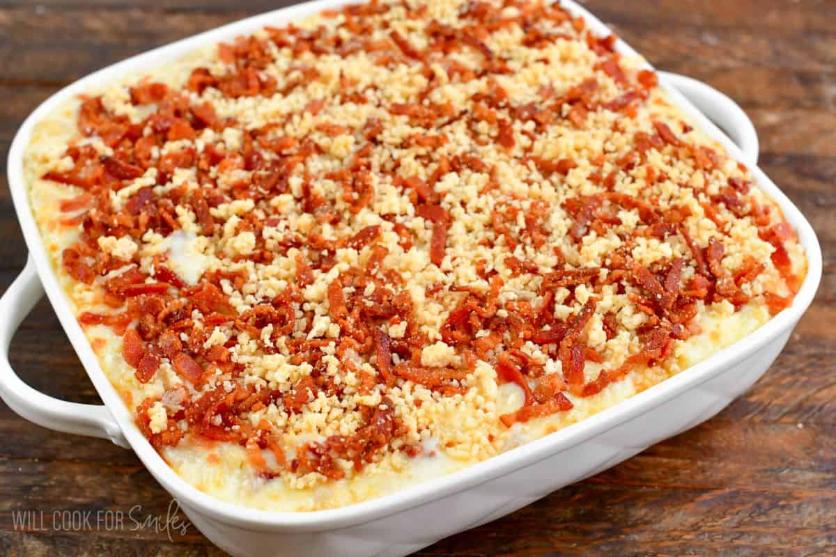 mac and cheese in a white baking dish with bacon panko topping after baking.