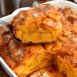 a slice of French toast casserole on top of the rest of the casserole in the baking dish.