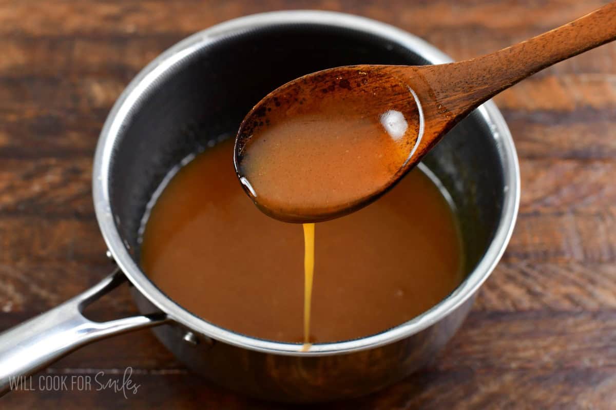 scooping some sweet buttery sauce for the top of French toast.