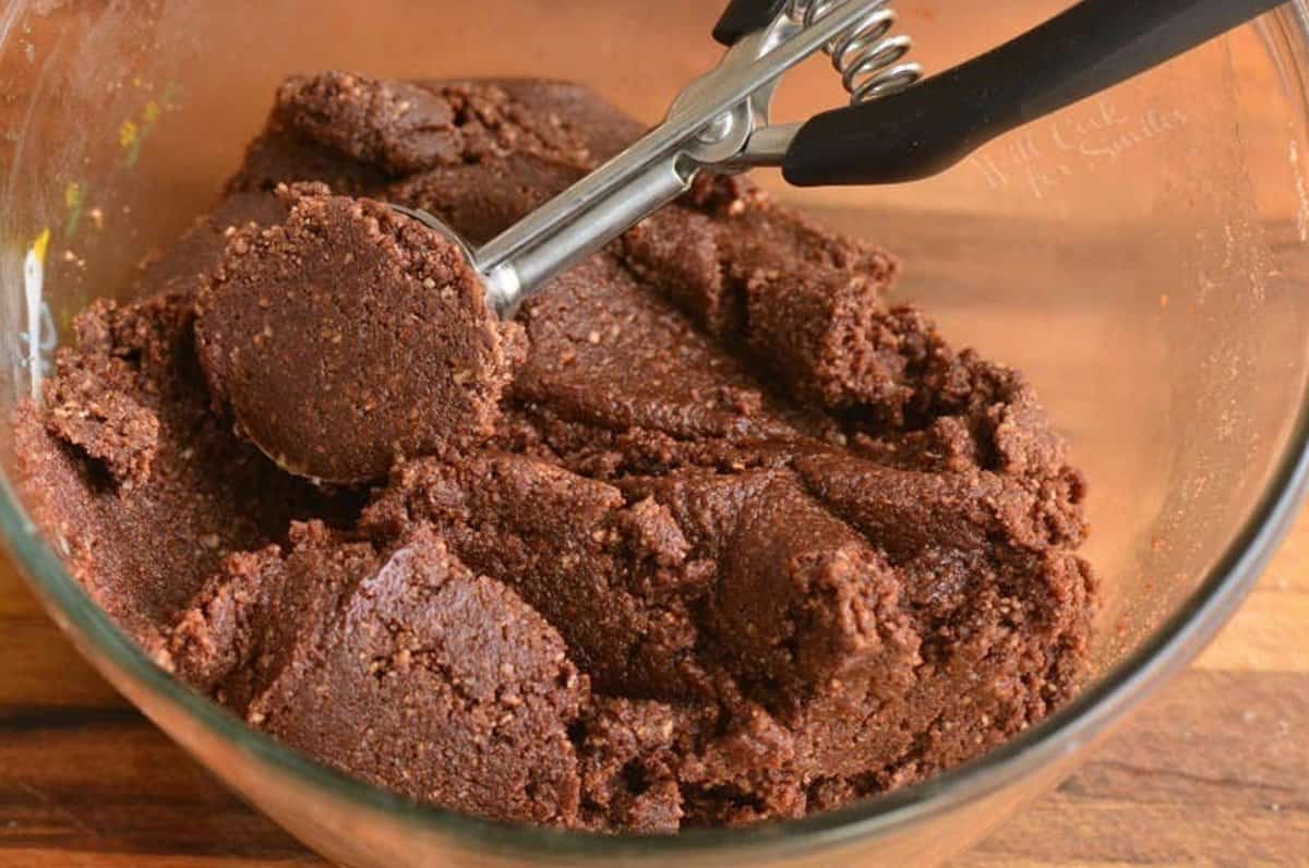 mixture for rum balls in the clear bowl and scooped with cookie scoop.