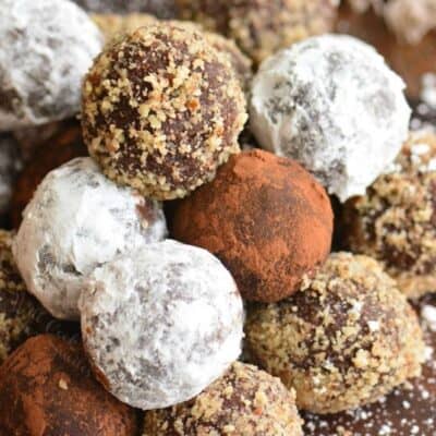 rum balls with three different coatings stacked in a pyramid.