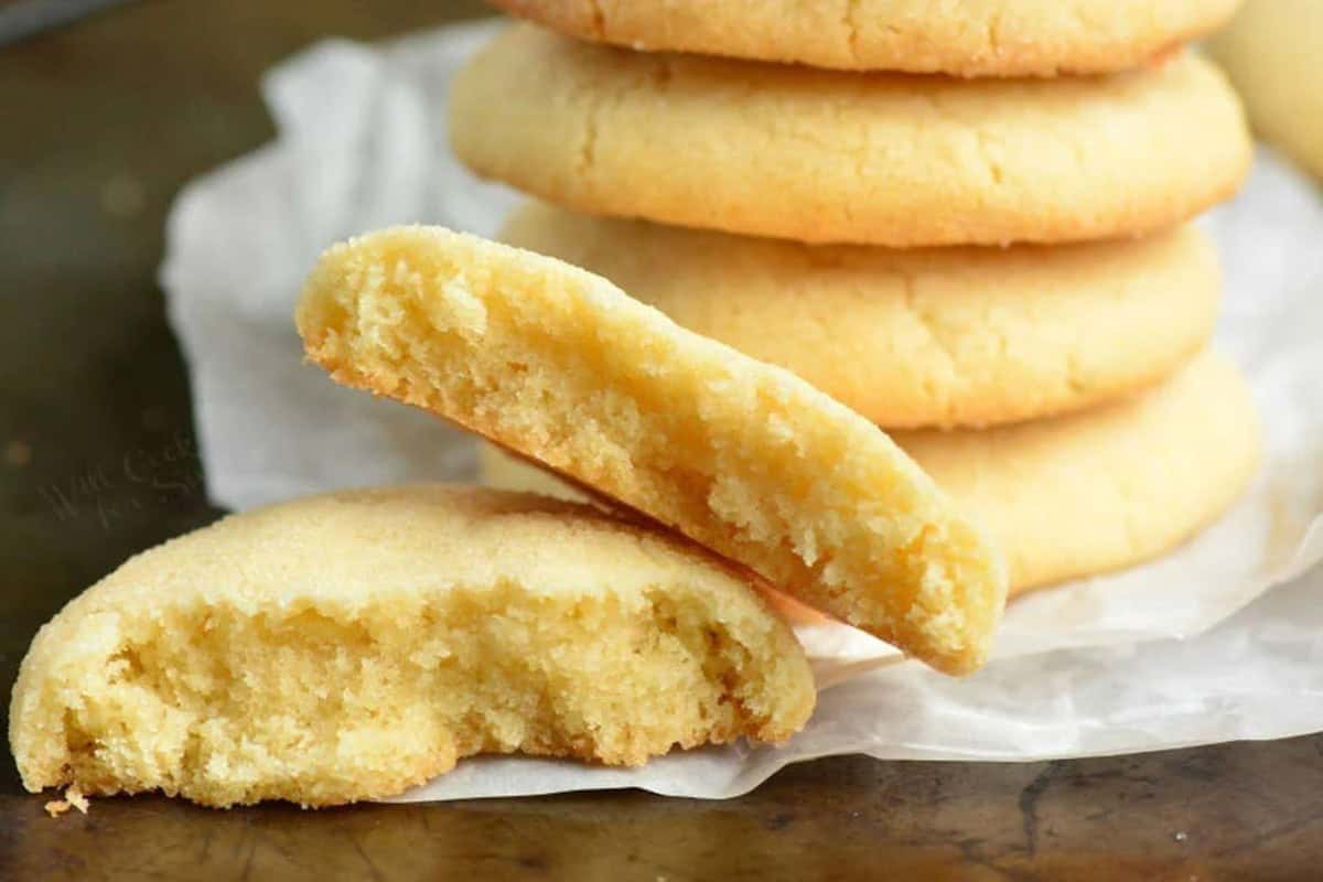 sugar cookie broke in half on a piece of wax paper on a baking sheet.