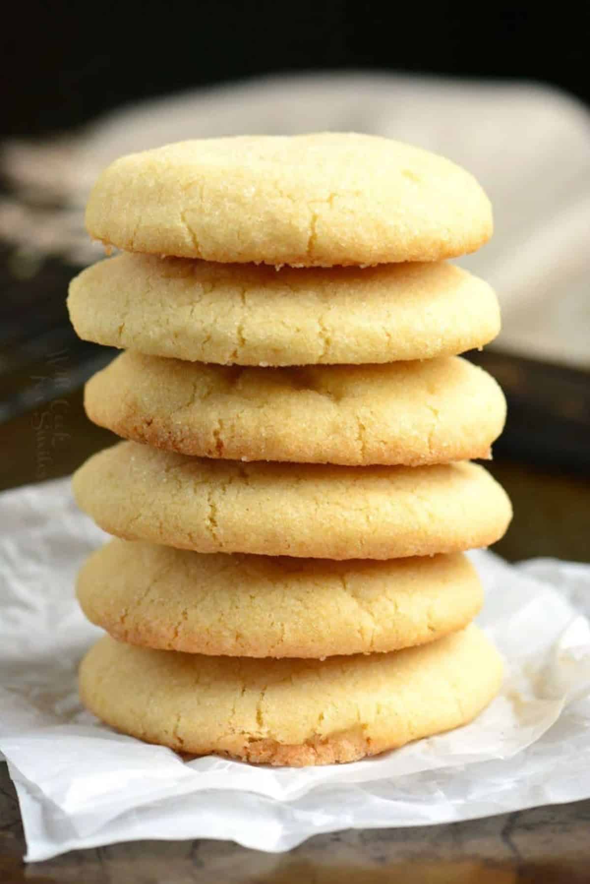 Soft sugar cookies in a stack on a peice of wax paper.