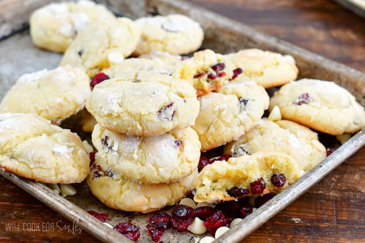 Many White Chocolate Cranberry Crinkle Cookies in the baking pan spread out.