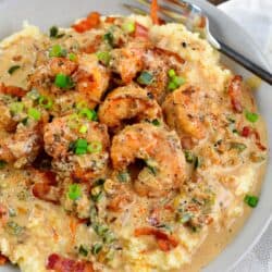 cheesy grits topped with Cajun shrimp crispy, bacon and Cajun cream sauce.