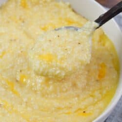 holding some cheesy grits in a spoon over the bowl.