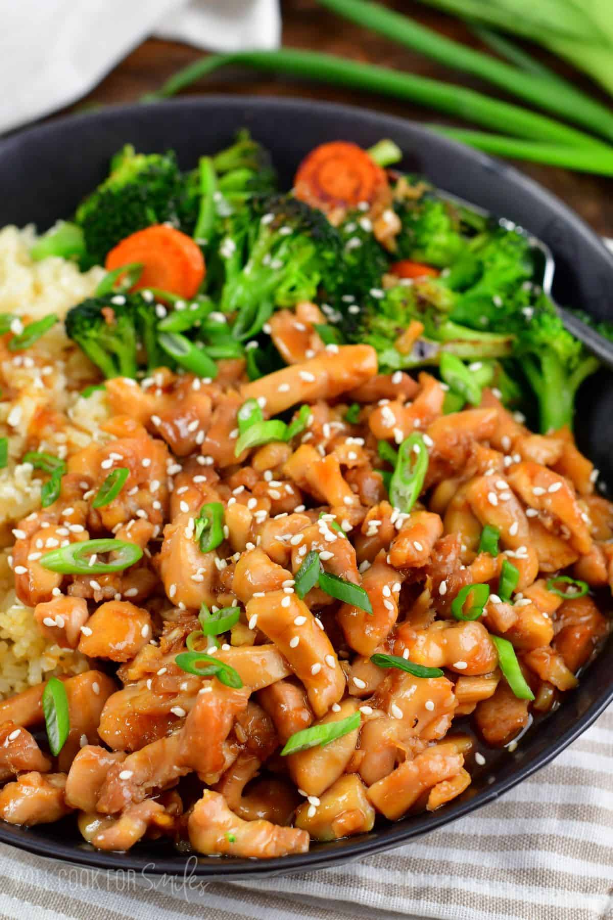 chicken teriyaki in the bowl with rice and some veggies.