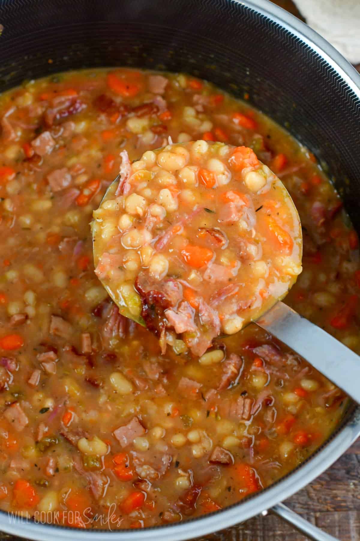 ladling out some ham and bean soup from the pot.