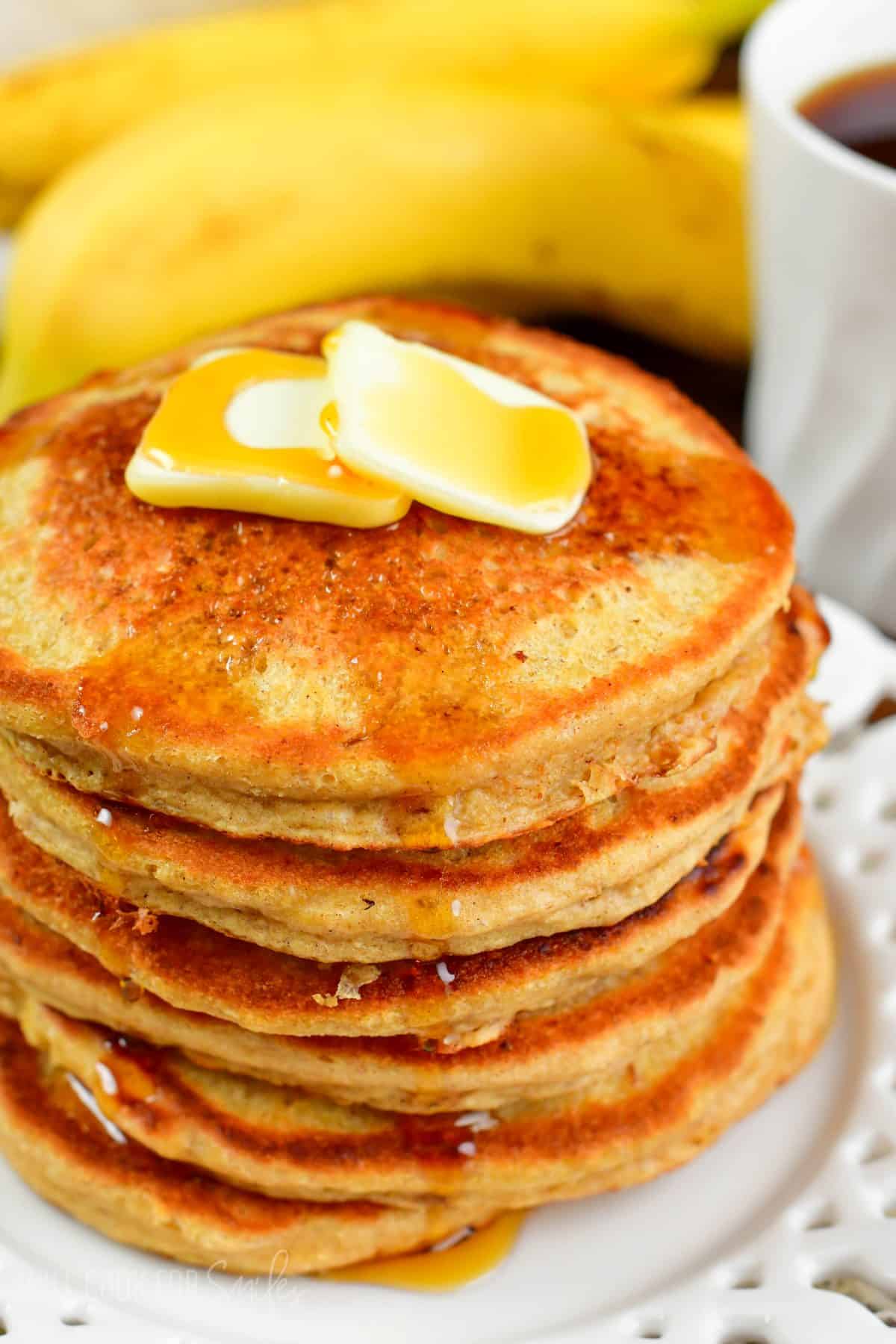 stack of several blender oatmeal pancakes topped with butter and syrup.