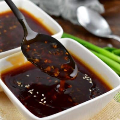 spooning out some teriyaki sauce and dripping off the spoon.