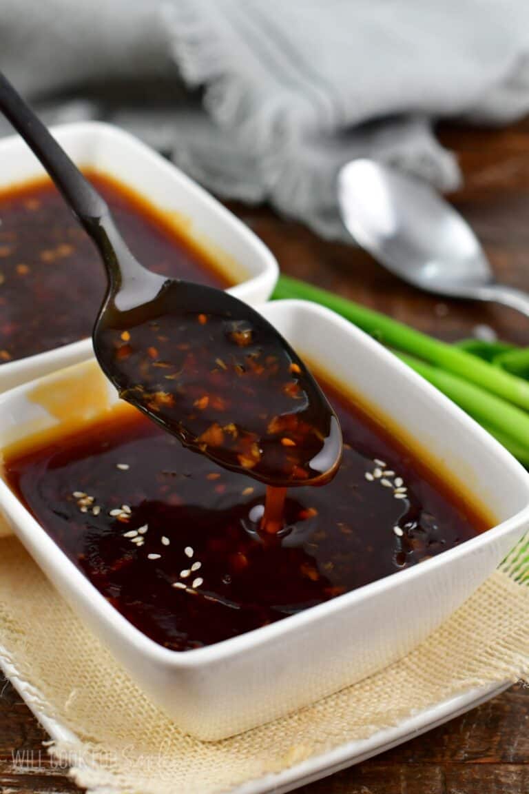 spooning out some teriyaki sauce and dripping off the spoon.